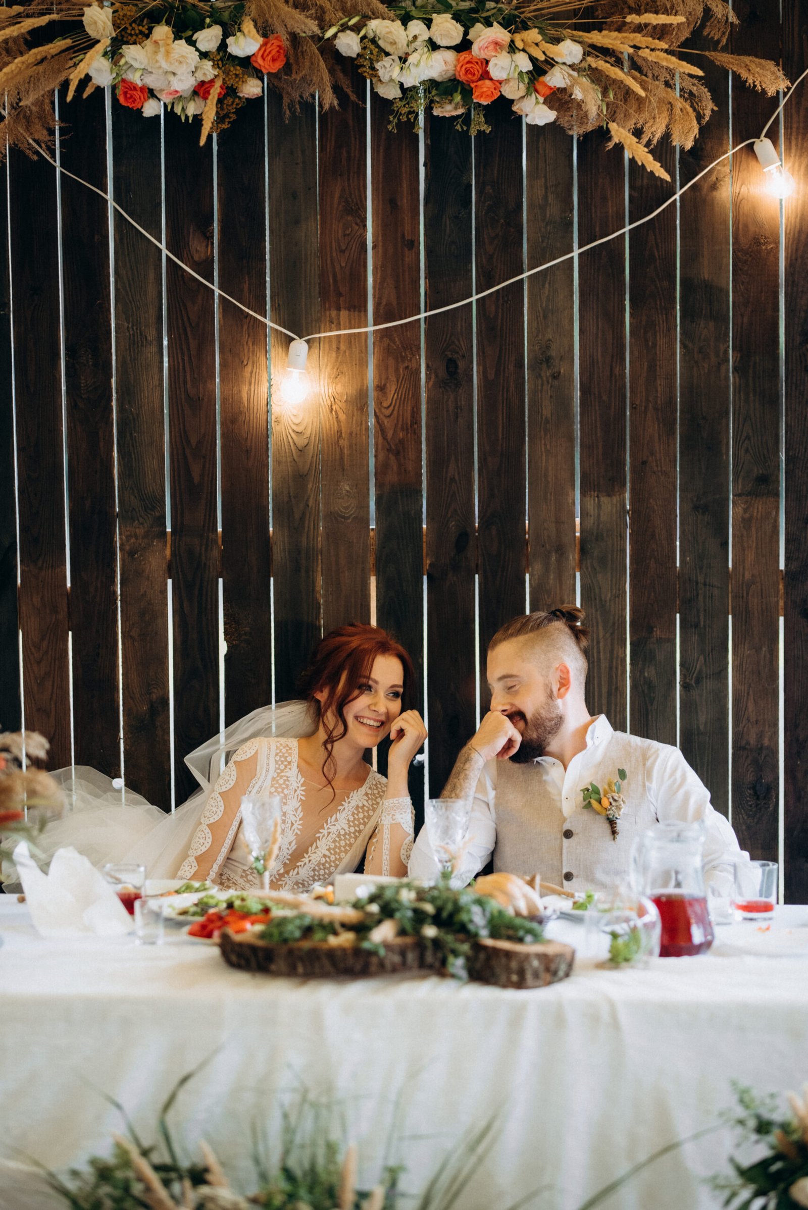 portrait of the newlyweds at the presidium at the wedding banquet